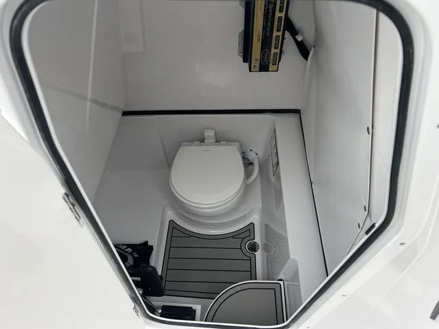 Slide: The Image of 2025 Sportsman Heritage 261 boat interior with compact marine toilet. - 12
