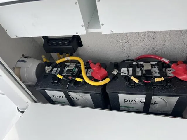 Slide: The Image of Battery compartment of 2025 Sportsman Heritage 261 boat with dry cell batteries. - 13