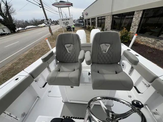 Slide: The Image of 2025 Sportsman Heritage 261 boat interior with dual gray seats and steering wheel. - 15