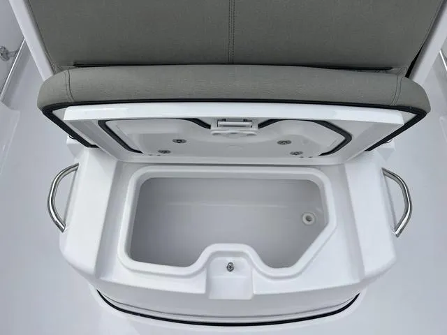 Slide: The Image of Open storage compartment on 2025 Sportsman Heritage 261 boat, featuring cushioned seating. - 19
