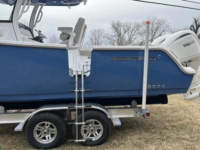 Slide: The Image of 2025 Sportsman Heritage 261 boat on trailer, featuring Yamaha engine and blue hull. - 24