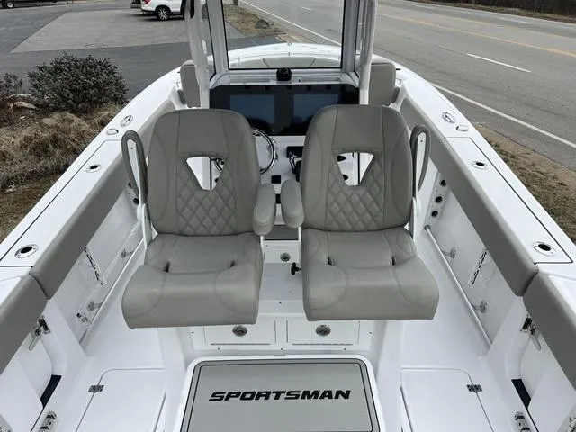 Slide: The Image of 2025 Sportsman Heritage 261 boat interior with dual gray seats and modern dashboard. - 29