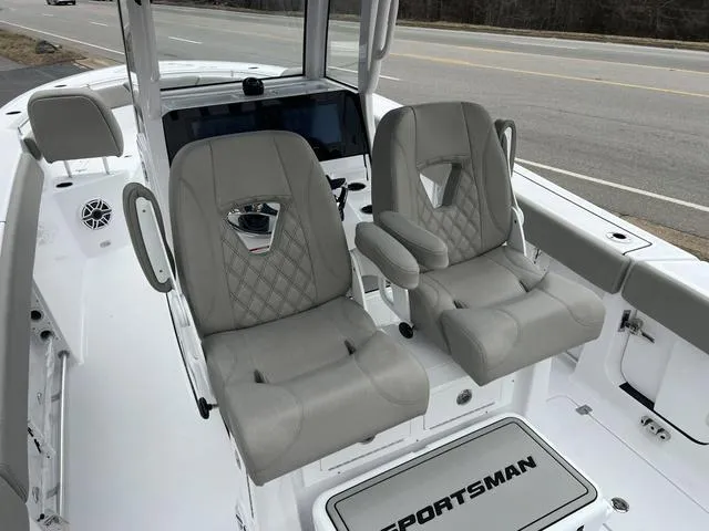 Slide: The Image of 2025 Sportsman Heritage 261 boat interior with dual gray seats and dashboard. - 30