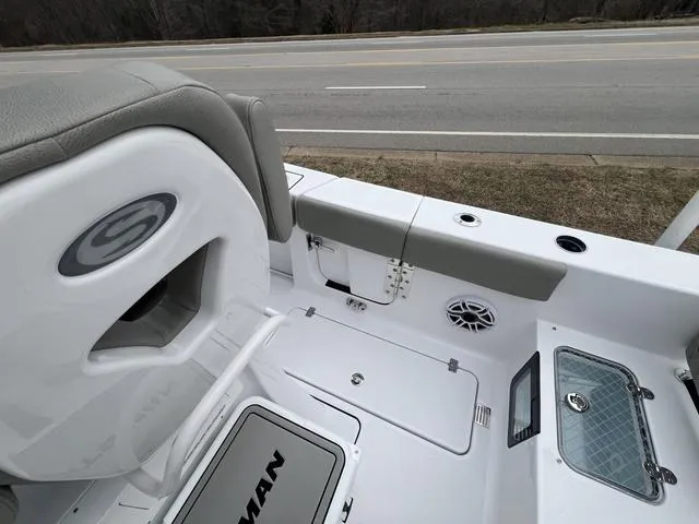Slide: The Image of 2025 Sportsman Heritage 261 boat interior with seating and storage compartments. - 7