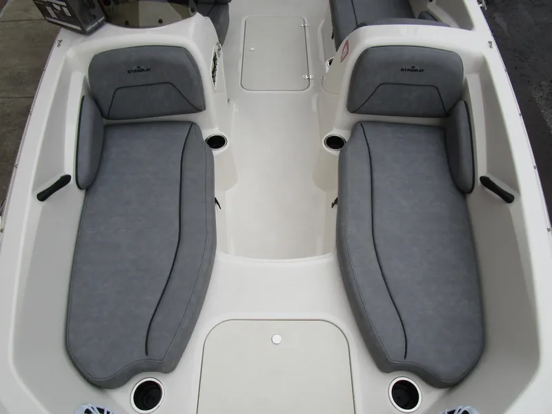Slide: The Image of 2022 Stingray 182 boat interior with gray cushioned seating and cup holders. - 12