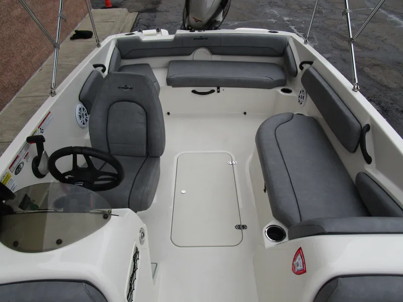 Slide: The Image of 2022 Stingray 182 boat interior with gray seating and steering wheel. - 13