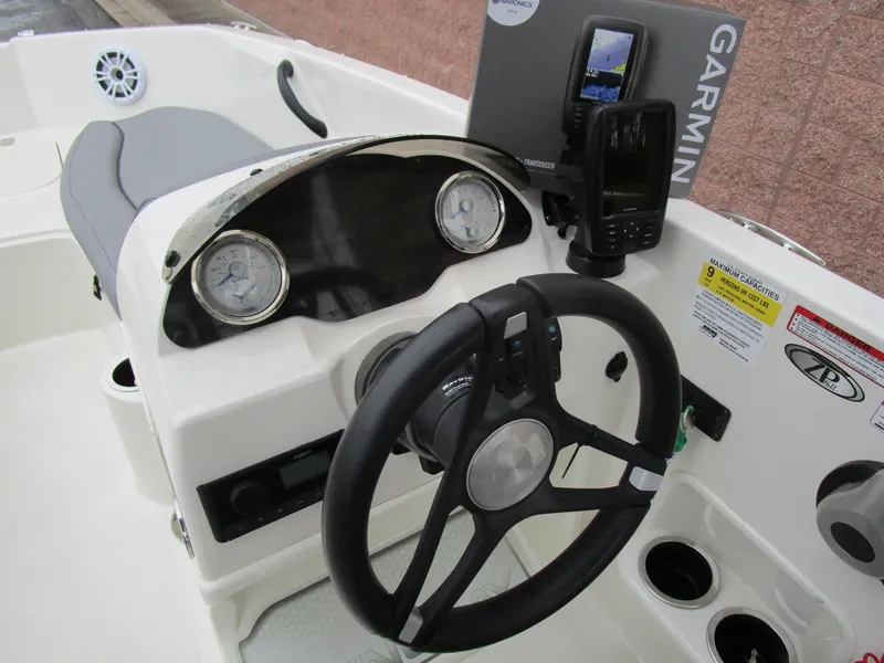 Slide: The Image of 2022 Stingray 182 boat dashboard with Garmin GPS, steering wheel, and gauges. - 14