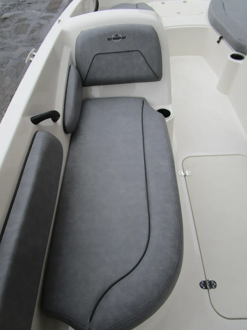 Slide: The Image of 2022 Stingray 182 boat interior with gray cushioned seating and storage compartments. - 15
