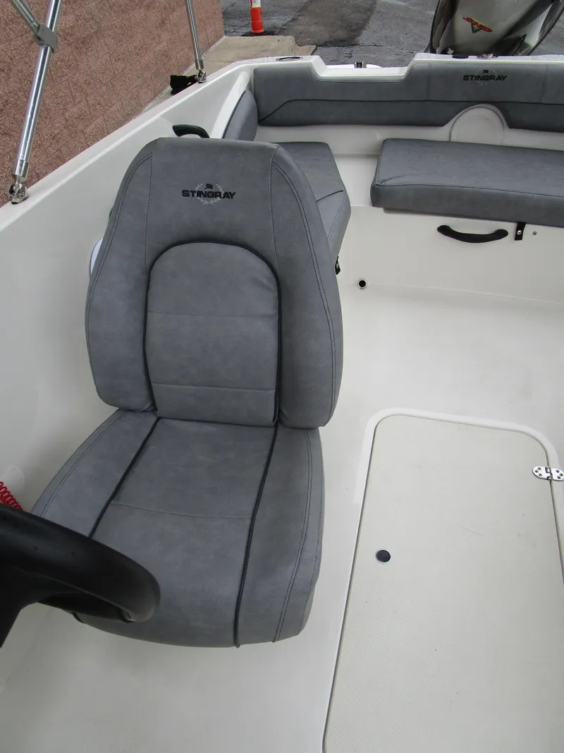 Slide: The Image of 2022 Stingray 182 boat interior with gray seating and steering wheel. - 16