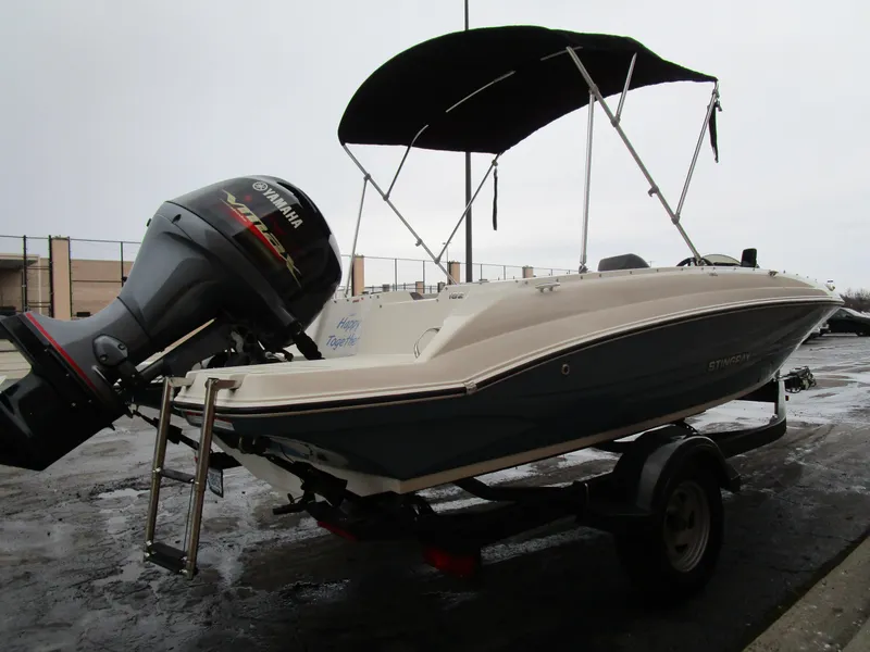 Slide: The Image of 2022 Stingray 182 boat with Yamaha outboard motor and canopy on trailer. - 6