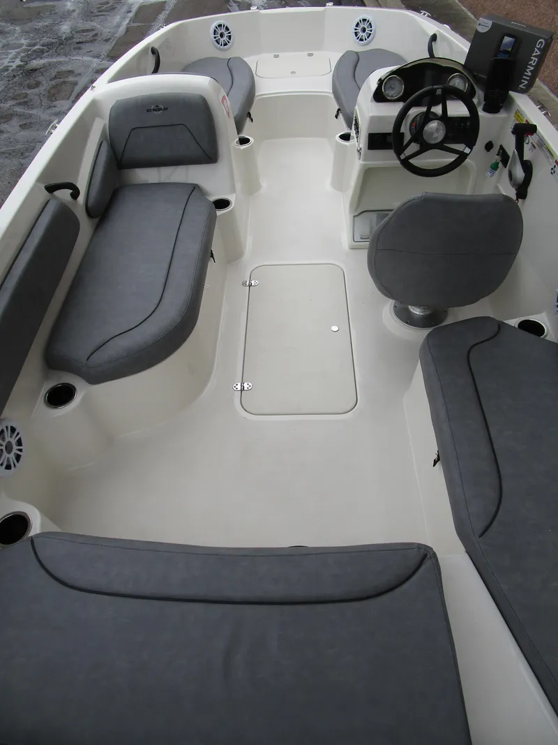 Slide: The Image of 2022 Stingray 182 boat interior with gray seating and steering console. - 9