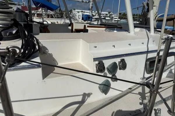 Slide: The Image of 1989 Catalina Morgan 440 sailboat deck with rigging and fittings in a marina. - 10
