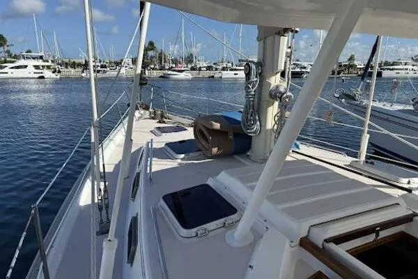 Slide: The Image of 1989 Catalina Morgan 440 sailboat docked at marina, clear sky, calm water. - 22
