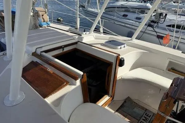 Slide: The Image of 1989 Catalina Morgan 440 sailboat cockpit with open hatch, docked at marina. - 23