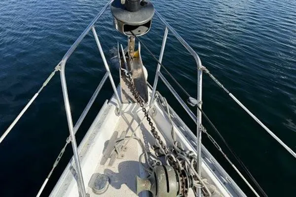 Slide: The Image of Bow of 1989 Catalina Morgan 440 sailboat with anchor and chain in calm water. - 24