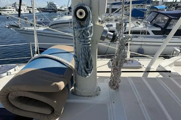 Slide: The Image of 1989 Catalina Morgan 440 sailboat deck with ropes and rolled mat in marina. - 25