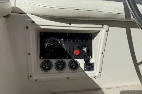 Slide: The Image of Control panel of a 1989 Catalina Morgan 440 sailboat, featuring gauges and switches. - 26