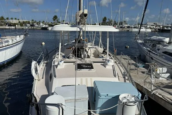 Slide: The Image of 1989 Catalina Morgan 440 sailboat docked at a marina under a clear blue sky. - 3