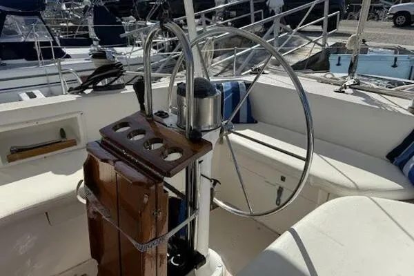Slide: The Image of Cockpit of 1989 Catalina Morgan 440 sailboat with steering wheel and wooden panel. - 41