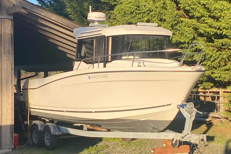 Slide: The Image of 2020 Jeanneau NC Sport 695 boat on trailer, parked outdoors. - 1