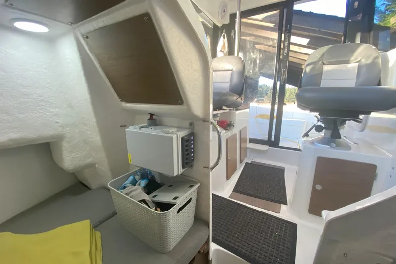 Slide: The Image of Interior of 2020 Jeanneau NC Sport 695 boat, featuring seating and storage area. - 11