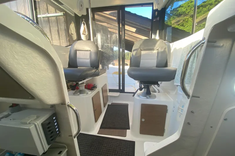 Slide: The Image of Interior of 2020 Jeanneau NC Sport 695 boat with two seats and modern design. - 12