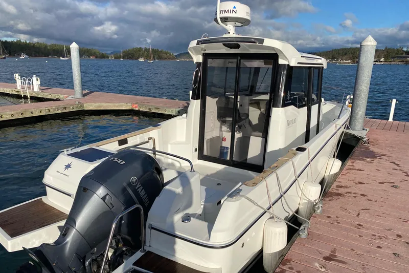 Slide: The Image of 2020 Jeanneau NC Sport 695 boat docked with Yamaha outboard motor. - 3