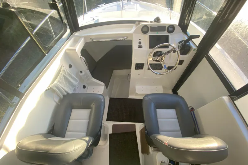 Slide: The Image of Interior of 2020 Jeanneau NC Sport 695 boat with steering wheel and seating. - 9