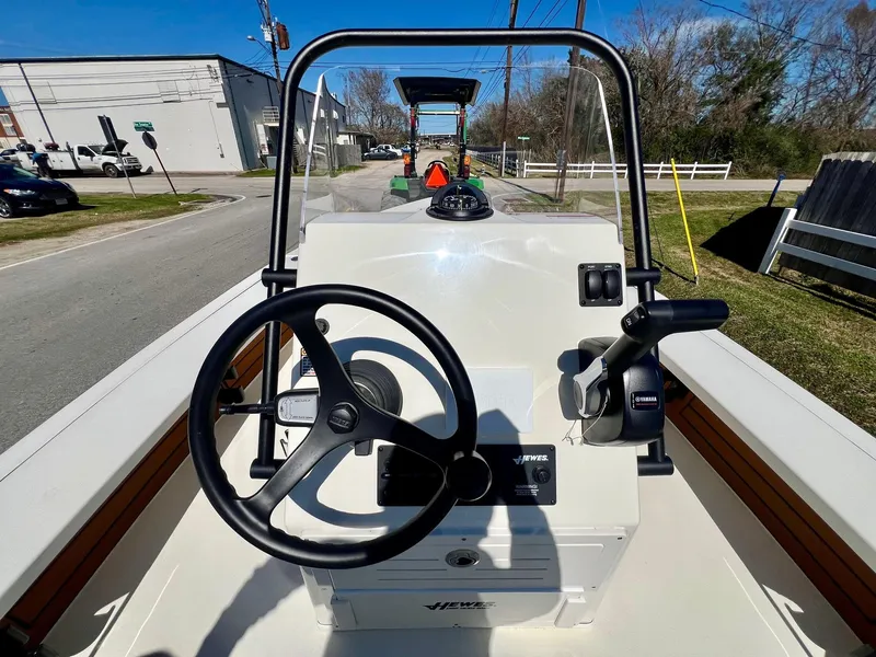 Slide: The Image of 2025 Hewes Redfisher 18 boat console with steering wheel and controls. - 10