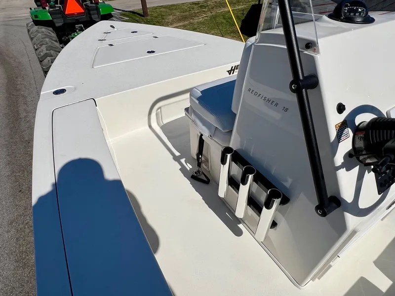Slide: The Image of 2025 Hewes Redfisher 18 boat interior with rod holders and seating. - 11
