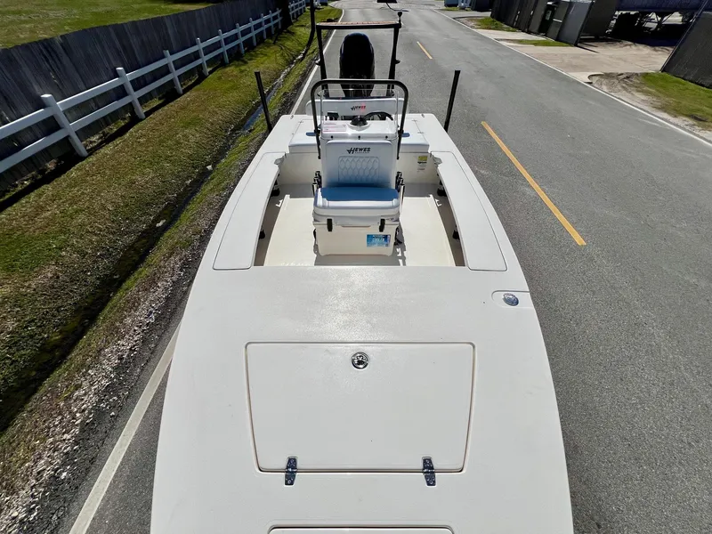 Slide: The Image of 2025 Hewes Redfisher 18 boat on road, showcasing deck and seating. - 14