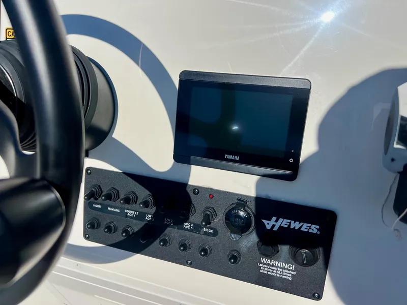 Slide: The Image of 2025 Hewes Redfisher 18 dashboard with Yamaha display and control panel. - 15