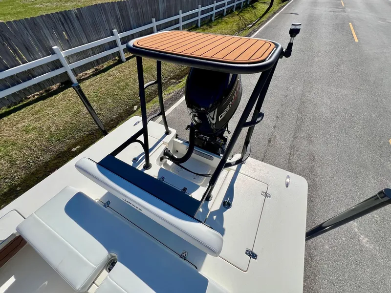 Slide: The Image of 2025 Hewes Redfisher 18 boat with elevated platform and outboard motor on a road. - 7