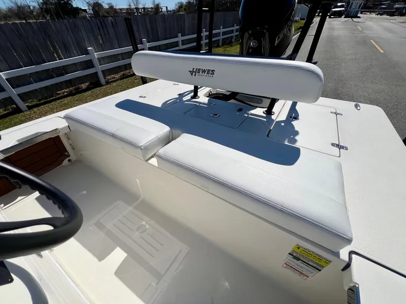 Slide: The Image of 2025 Hewes Redfisher 18 boat interior with white seating and steering wheel. - 9