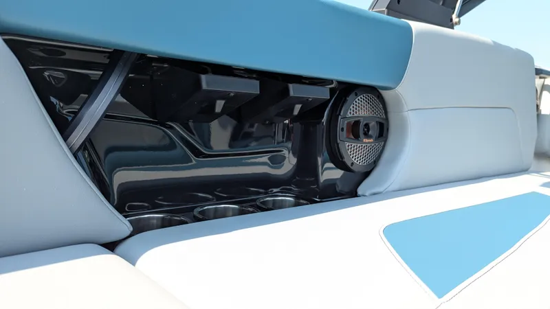 Slide: The Image of 2025 MasterCraft NXT23 boat interior with speaker and cup holders. - 10