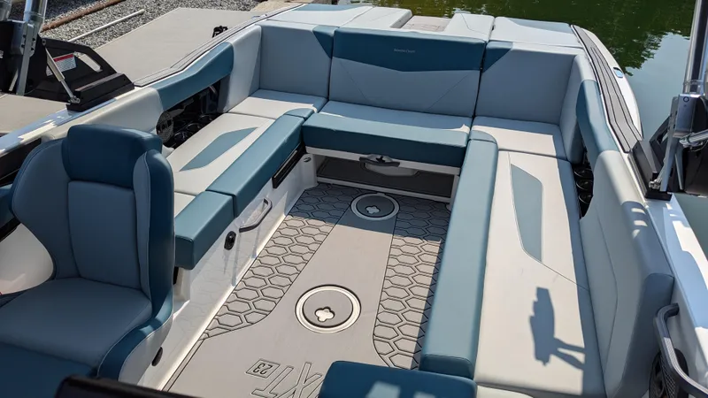 Slide: The Image of 2025 MasterCraft NXT23 boat interior with spacious seating and modern design. - 14