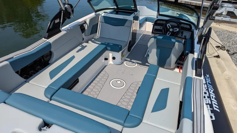 Slide: The Image of 2025 MasterCraft NXT23 boat interior with spacious seating and modern dashboard. - 8