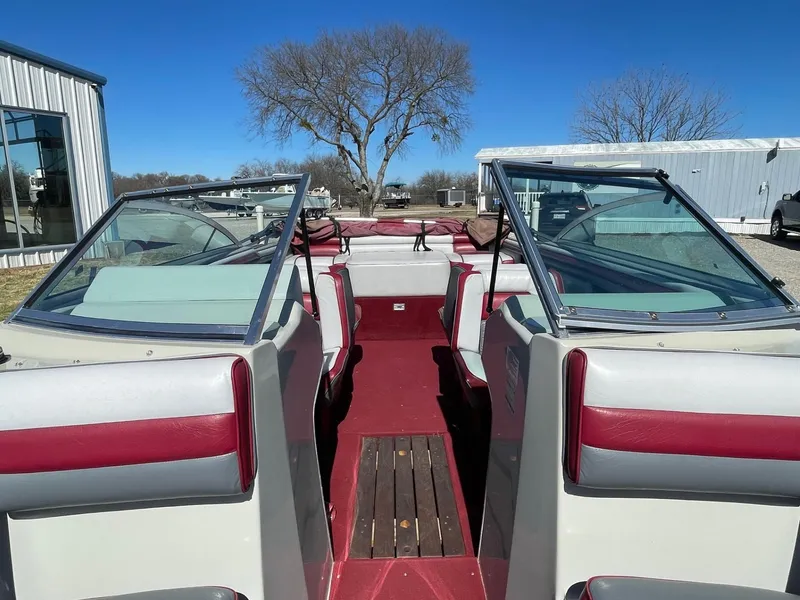 Slide: The Image of 1988 Four Winns 200 Horizon boat interior with red and white seating, docked outdoors. - 3