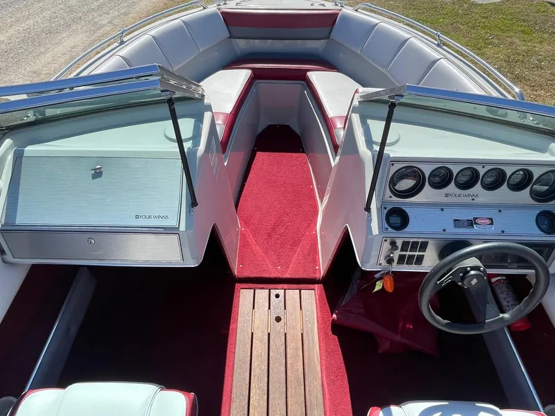 Slide: The Image of 1988 Four Winns 200 Horizon boat interior with red carpet and dual consoles. - 4