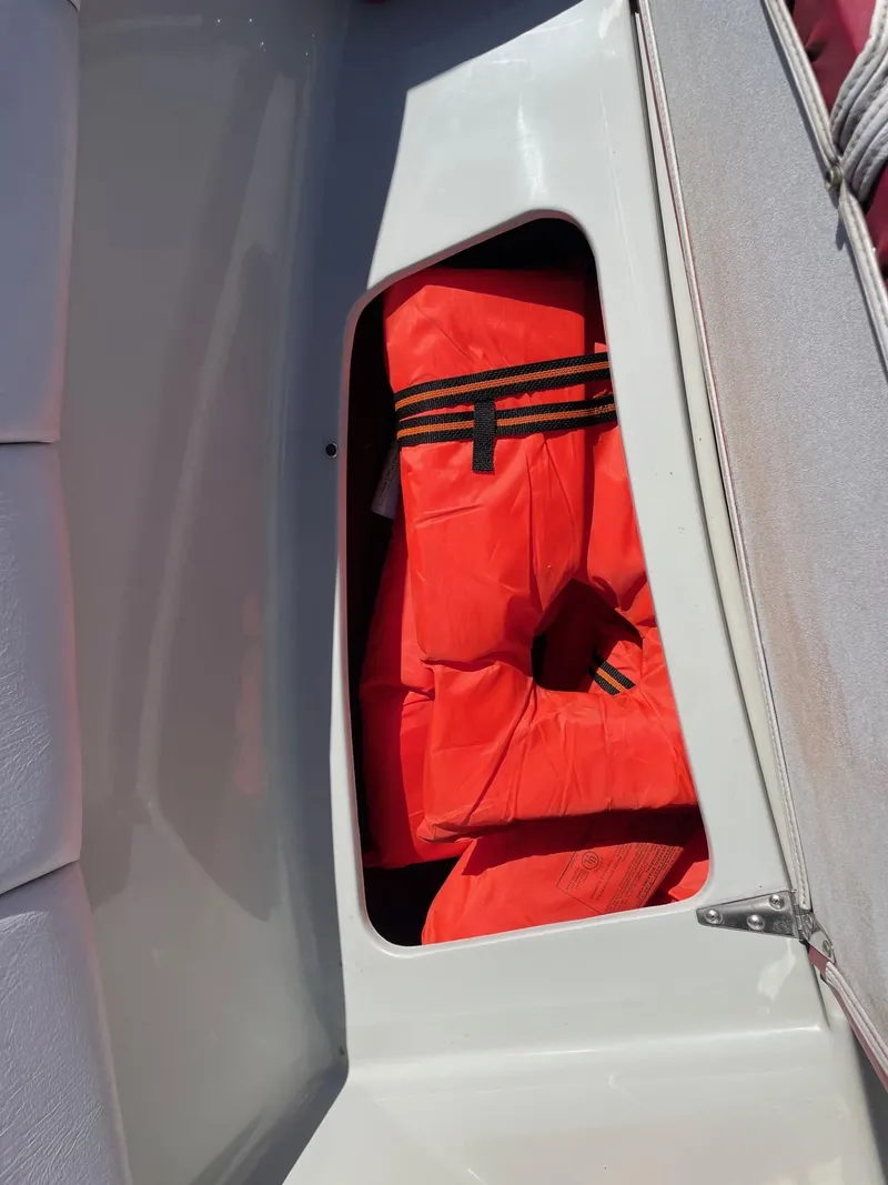 Slide: The Image of 1988 Four Winns 200 Horizon boat storage with orange life jackets. - 6