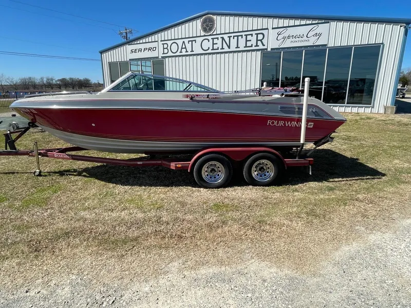 Slide: The Image of 1988 Four Winns 200 Horizon boat on trailer outside a boat center. - 8