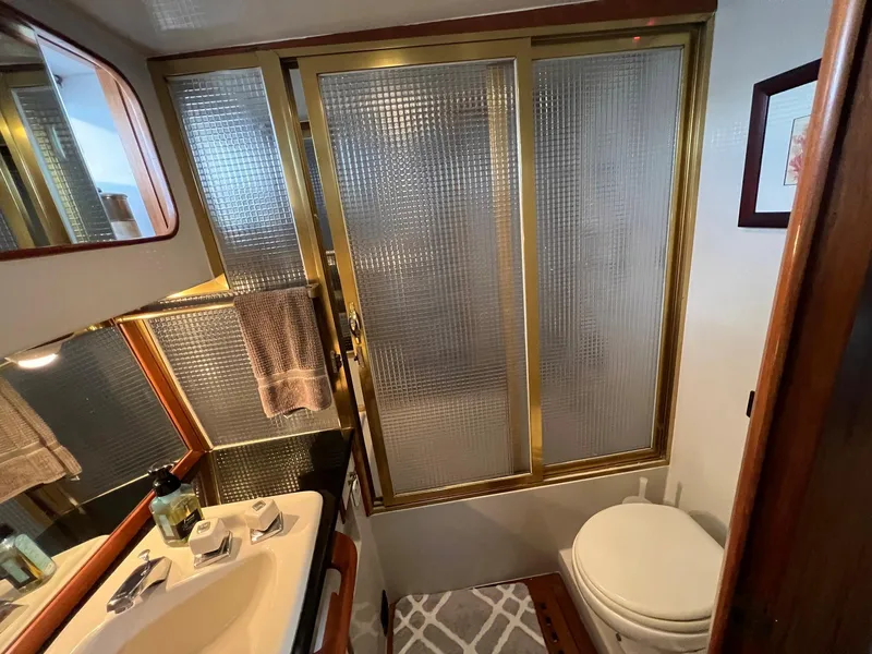 Slide: The Image of Bathroom interior of 1988 President Motor Yacht with shower, sink, and toilet. - 10