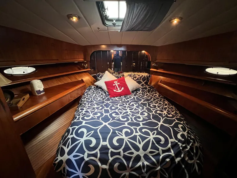 Slide: The Image of Luxurious 1988 President Motor Yacht cabin with nautical-themed bedding and elegant wood paneling. - 12