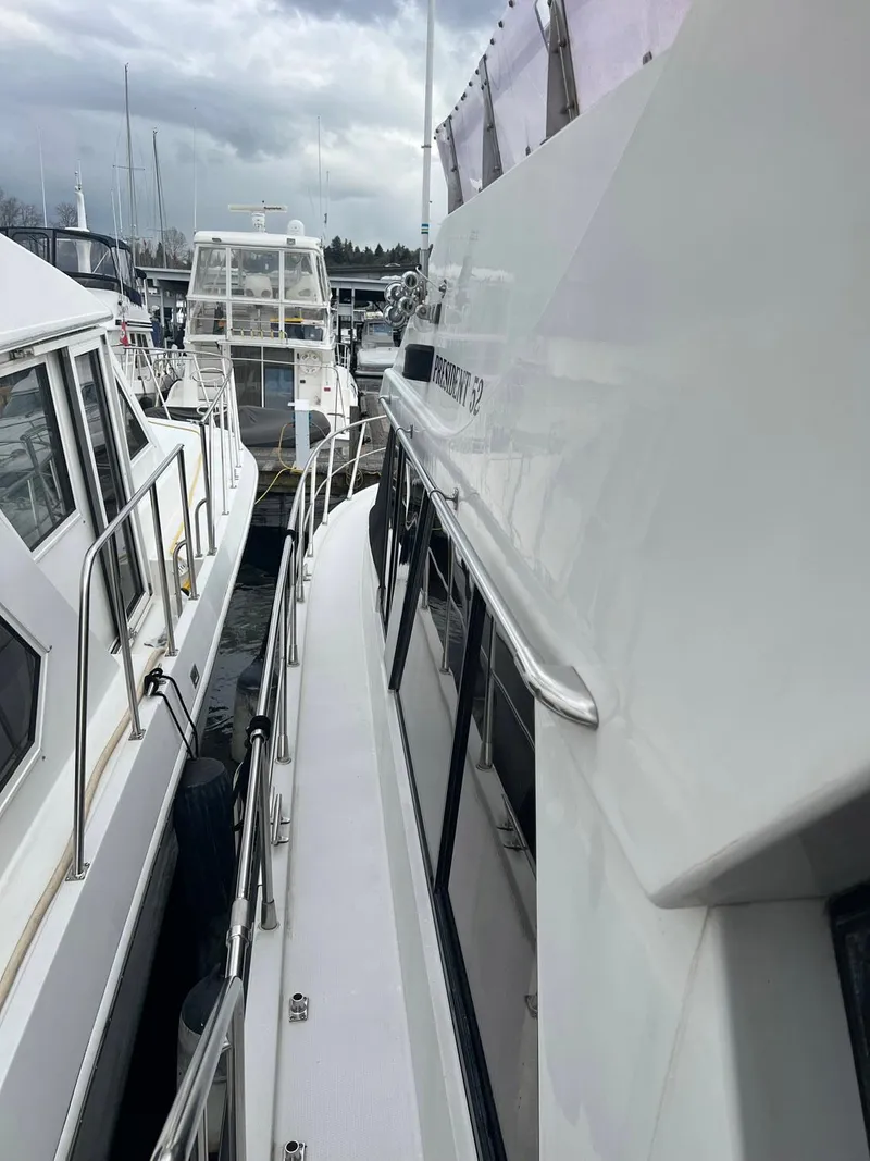 Slide: The Image of 1988 President Motor Yacht docked among other boats under cloudy skies. - 15