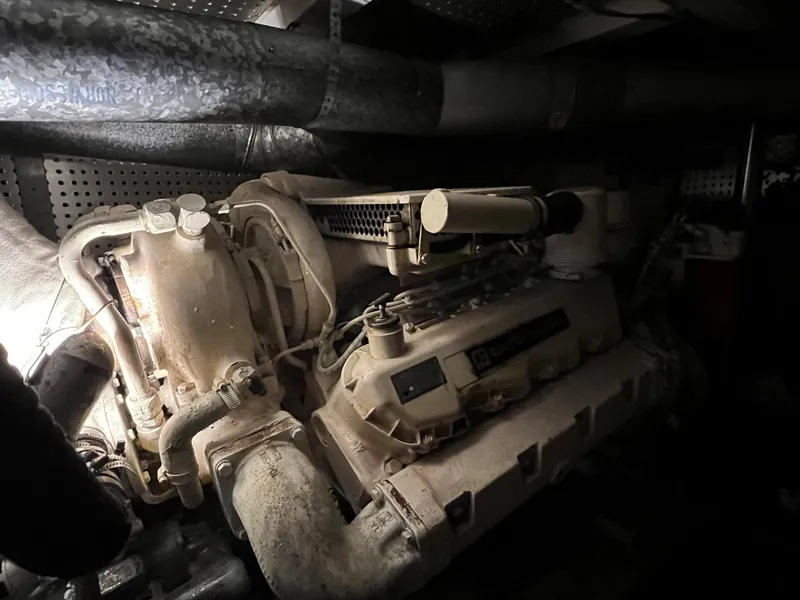 Slide: The Image of Engine room of 1988 President Motor Yacht, showcasing mechanical components and piping. - 24