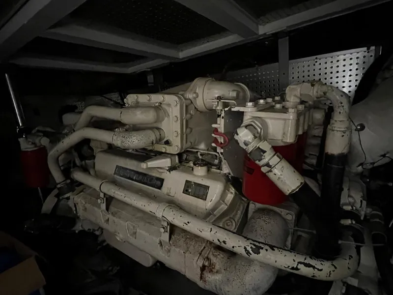 Slide: The Image of Engine room of a 1988 President Motor Yacht, featuring complex machinery and pipes. - 25