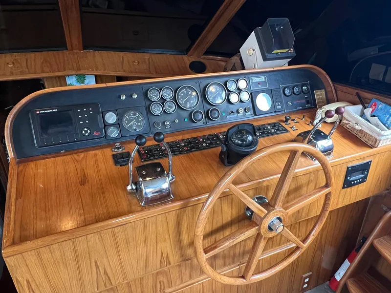 Slide: The Image of 1988 President Motor Yacht helm with wooden steering wheel and control panel. - 4