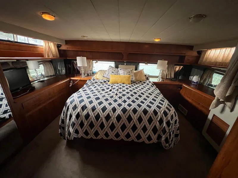Slide: The Image of Luxurious bedroom interior of a 1988 President Motor Yacht with patterned bedding. - 9