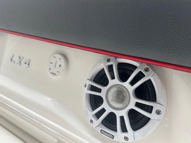 Slide: The Image of 2024 Regal LX4 boat interior with Fusion speaker and control panel. - 14
