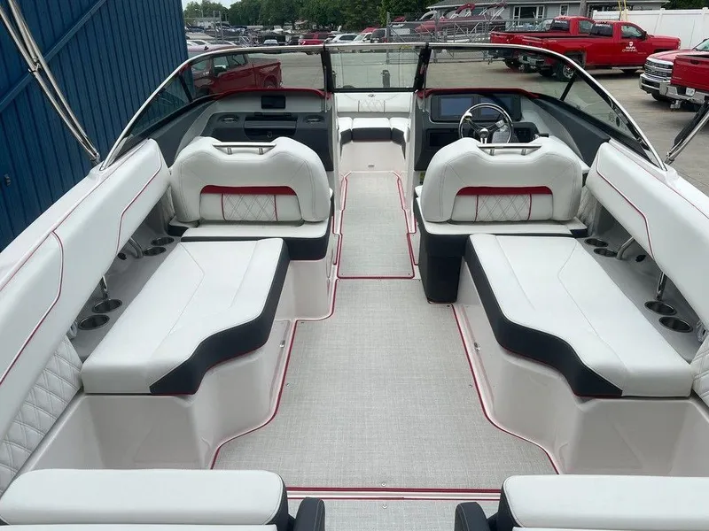Slide: The Image of 2024 Regal LX4 boat interior with white seating and red accents. - 3